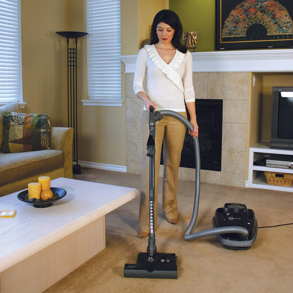 Woman vacuuming with a SEBO Airbelt K3